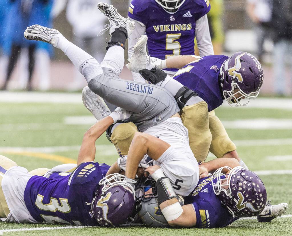 Multiple Lake Stevens players tackle Meads Keegan Mallon during the 4A state playoff game on Saturday, Nov. 16, 2024 in Lake Stevens, Washington. (Olivia Vanni / The Herald)