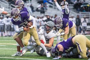 Lake Stevens’ Jayshon Limar runs through multiple tackles into the end zone for a touchdown during the 4A state playoff game against Mead on Saturday, Nov. 16, 2024 in Lake Stevens, Washington. (Olivia Vanni / The Herald)