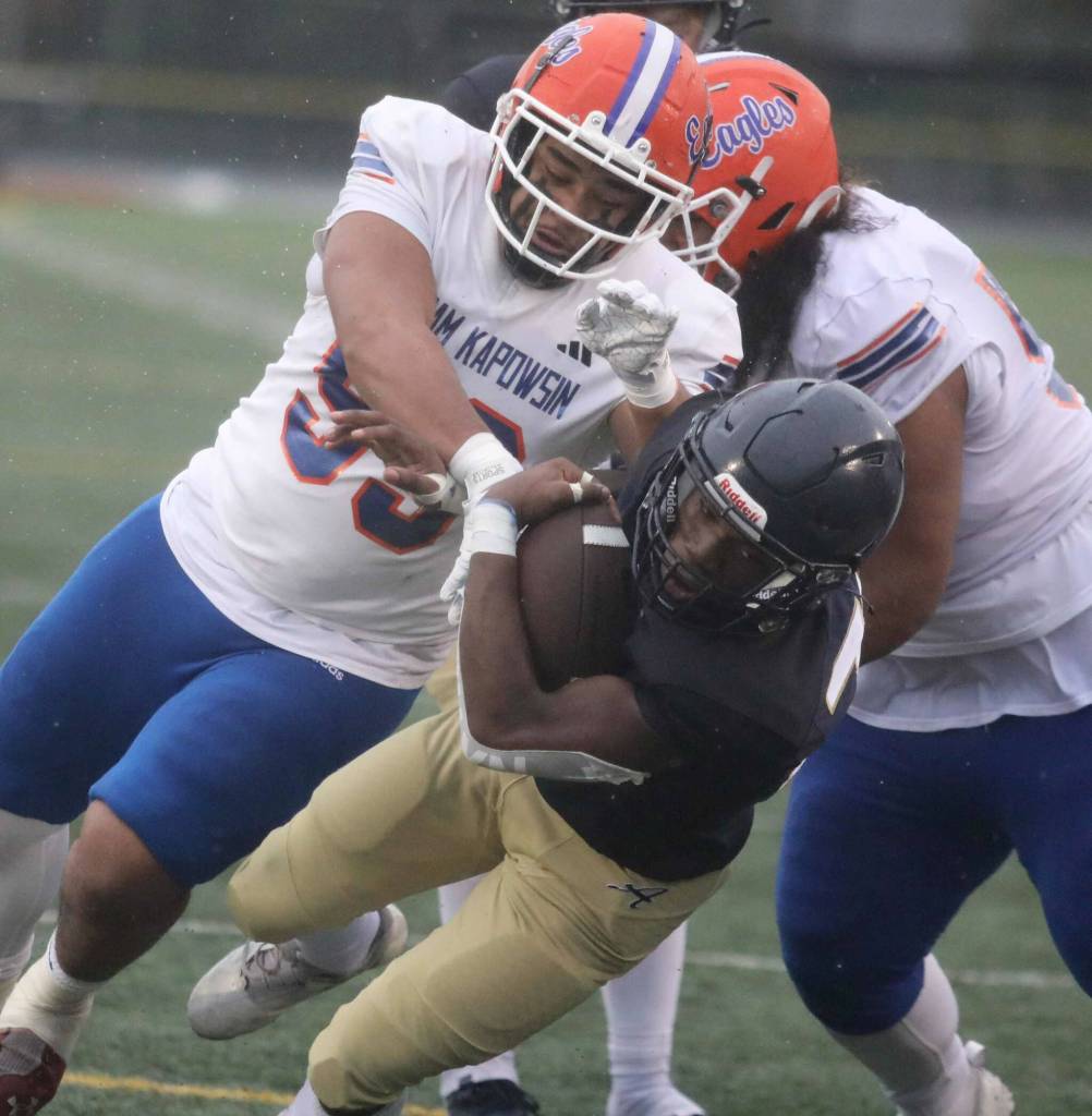 Arlington junior running back Dirci Ngondo gets tackled during a first-round game of the Class 4A state tournament against Graham-Kapowsin in Arlington, Wash., on Saturday, Nov. 16, 2024. The Eagles won, 42-6. (Taras McCurdie / The Herald)