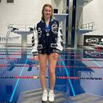 Glacier Peak High School diver Addison Farman stands on the championship platform after winning her second straight Class 4A 1-meter diving title at the King Country Aquatics Center on Thursday, Nov. 14, 2024. (Photo courtesy of Jamie Farman)