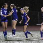 Lake Stevens’ Noelani Tupua jumps in the air after scoring with teammate Cora Jones during the 4A state playoff game against Richland on Wednesday, Nov. 13, 2024 in Lake Stevens, Washington. (Olivia Vanni / The Herald)