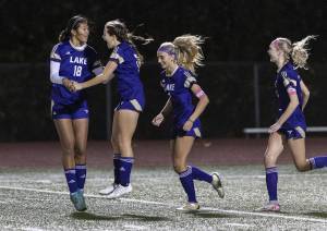 Lake Stevens’ Noelani Tupua jumps in the air after scoring with teammate Cora Jones during the 4A state playoff game against Richland on Wednesday, Nov. 13, 2024 in Lake Stevens, Washington. (Olivia Vanni / The Herald)