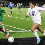 Lake Stevens sophomore forward Noelani Tupua dribbles the ball down the sideline in the Class 4A state title game against second-seeded Woodinville at Sparks Stadium in Puyallup, Wash., on Saturday, Nov. 23, 2024. This marked the first state title in program history for the Vikings. (Taras McCurdie / The Herald)