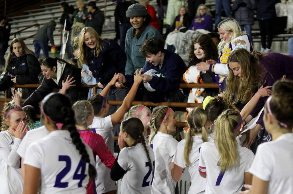 Players for the eighth-seeded Lake Stevens High School girls soccer team celebrate their 1-0 victory against second-seeded Woodinville in the Class 4A state title game at Sparks Stadium in Puyallup, Wash., on Saturday, Nov. 23, 2024. This marked the first state title in program history for the Vikings. (Taras McCurdie / The Herald)