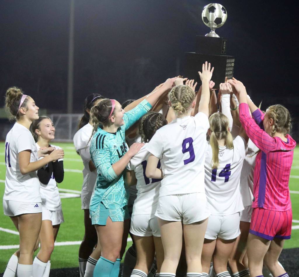 Players for the eighth-seeded Lake Stevens High School girls soccer team celebrate their 1-0 victory against second-seeded Woodinville in the Class 4A state title game at Sparks Stadium in Puyallup, Wash., on Saturday, Nov. 23, 2024. This marked the first state title in program history for the Vikings. (Taras McCurdie / The Herald)