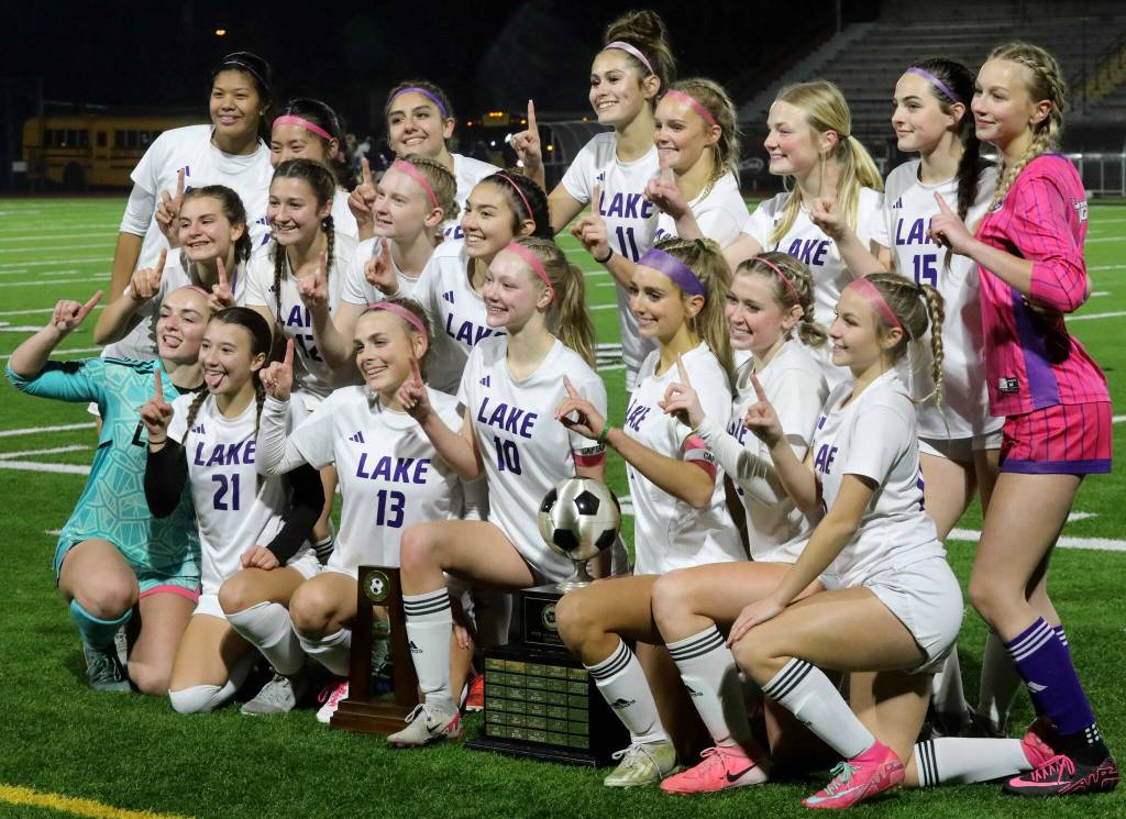 Players for the eighth-seeded Lake Stevens High School girls soccer team celebrate their 1-0 victory against second-seeded Woodinville in the Class 4A state title game at Sparks Stadium in Puyallup, Wash., on Saturday, Nov. 23, 2024. This marked the first state title in program history for the Vikings. (Taras McCurdie / The Herald)