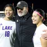 Lake Stevens coach Sam Ford smiles with Noelani Tupua, left, and her sister, Keira, after a 1-0 win against second-seeded Woodinville in the Class 4A state title game at Sparks Stadium in Puyallup, Wash., on Saturday, Nov. 23, 2024. This marked the first state title in program history for the Vikings. (Taras McCurdie / The Herald)