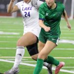 Lake Stevens junior forward Keira Tupua battles for the ball in the Class 4A state title game against second-seeded Woodinville at Sparks Stadium in Puyallup, Wash., on Saturday, Nov. 23, 2024. This marked the first state title in program history for the Vikings. (Taras McCurdie / The Herald)