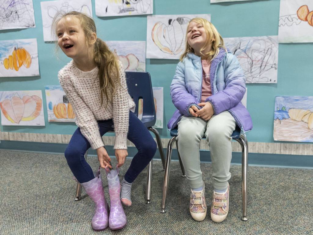 Highland Elementary kindergarteners Angie Furlan, 5, left, Nova Geary, 6, laugh as they talk about what a turkey would say if it could talk on Tuesday, Nov. 26, 2024 in Lake Stevens, Washington. (Olivia Vanni / The Herald)