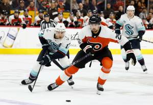 Flyers center Ryan Poehling (right) skates after the puck past Seattle Kraken center Jaden Schwartz on Saturday, Feb. 10, 2024. The Kraken are currently 11-10 with one overtime loss through 22 games of the 2024-25 season. (Yong Kim/Tribune News Service)