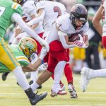 Archbishop Murphys Jevin Madison runs the ball while having his jersey pulled during the 2A semifinal game against Tumwater on Saturday, Nov. 30, 2024 in Tumwater, Washington. (Olivia Vanni / The Herald)