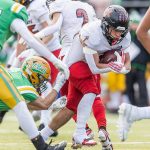 Archbishop Murphy’s Jevin Madison runs the ball while having his jersey pulled during the 2A semifinal game against Tumwater on Saturday, Nov. 30, 2024 in Tumwater, Washington.  (Olivia Vanni / The Herald)