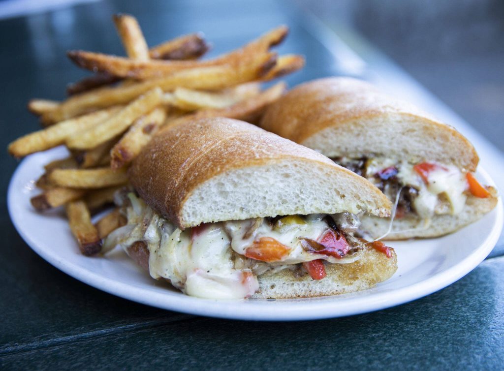 The Woodinville Cheesesteak with thinly-shaved ribeye, swiss cheese, red peppers, mushrooms, onions, banana peppers, tarragon aioli available at the Woodinville Tavern. (Olivia Vanni / The Herald)