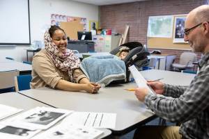 Refugee and Immigrant Services Northwest Senior Associate ESL Instructor James Wilcox, right, works on speaking and writing with Anfal Zaroug, 32, who is accompanied by her daughter Celia Hassen, 6 months, on Friday, Nov. 15, 2024 in Everett, Washington. (Olivia Vanni / The Herald)
