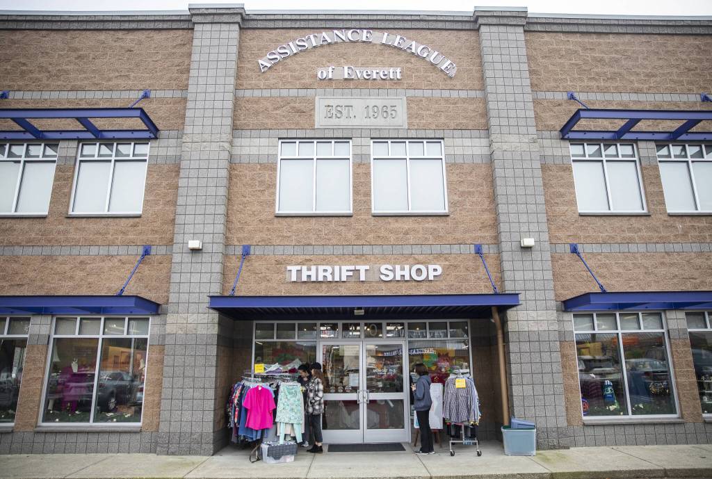 People browse the outside racks at the Assistance League of Everetts Thrift Store on Monday, Dec. 2, 2024 in Everett, Washington. (Olivia Vanni / The Herald)