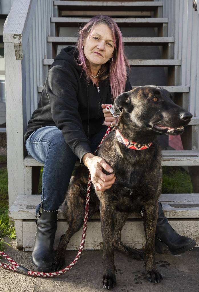 Kristy Kaminshine, who has frequently relied on Esthers Place since 2021, with her new dog Hazel on Wednesday, Dec. 4, 2024 in Everett, Washington. Kaminshine recently moved into her own one bedroom apartment and finally feels like she is moving in the right direction. (Olivia Vanni / The Herald)