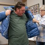 Kathy Carroll, right, helps Chris Angelbreath try on a winter coat on Monday, Dec. 2, 2024, at the Marysville Cold Weather Shelter in Marysville, Washington. (Will Geschke / The Herald)