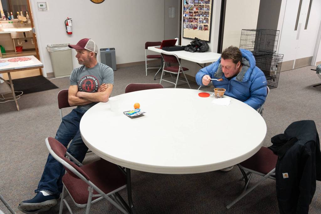 Howard Cartwright, left, and Chris Angelbreath on Monday, Dec. 2, 2024, at the Marysville Cold Weather Shelter in Marysville, Washington. (Will Geschke / The Herald)