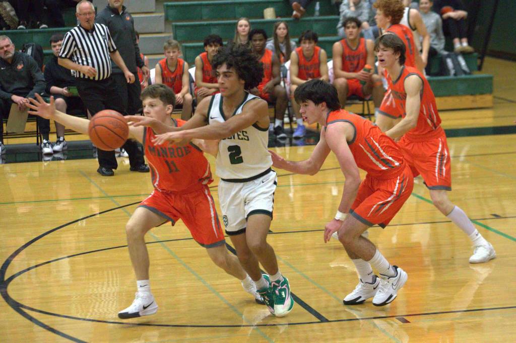 Monroe's Wyatt Prohn (11) and Jackson's Seamus Williams (2) battle for a ball in a non-league game at Jackson High School on Dec. 3, 2024. (Aaron Coe / The Herald)
