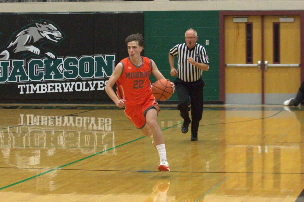Monroes Isaiah Kiehl bring the ball up the court in a non-league game at Jackson High School on Dec. 3, 2024. (Aaron Coe / The Herald)