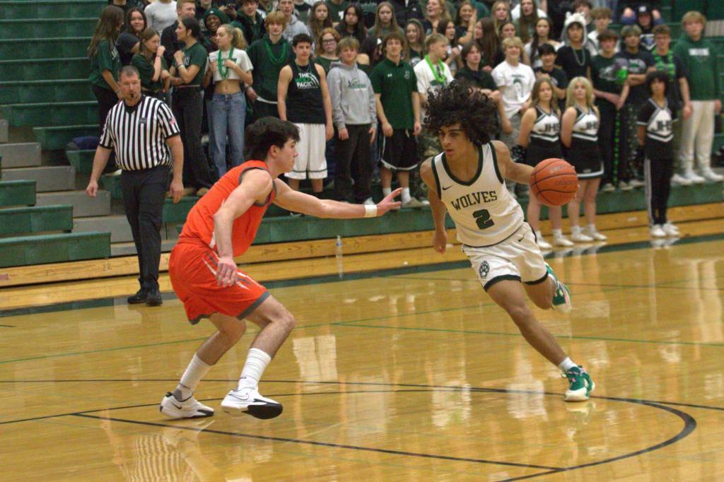 Jackson point guard Seamus Williams (2) tries to drive by Monroe Kieren Greear in a non-league game at Jackson High School on Dec. 3, 2024. (Aaron Coe / The Herald)