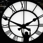 Electric Time technician Dan LaMoore adjusts a clock hand on a 1000-lb., 12-foot diameter clock constructed for a resort in Vietnam, Tuesday, March 9, 2021, in Medfield, Mass. Daylight saving time begins at 2 a.m. local time Sunday, March 14, 2021, when clocks are set ahead one hour. (AP Photo/Elise Amendola)