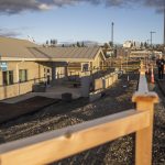 People walk past the public restroom at the Port of Everett that now sit lower than the renovated parking lot on Monday, Dec. 9, 2024 in Everett, Washington. (Olivia Vanni / The Herald)