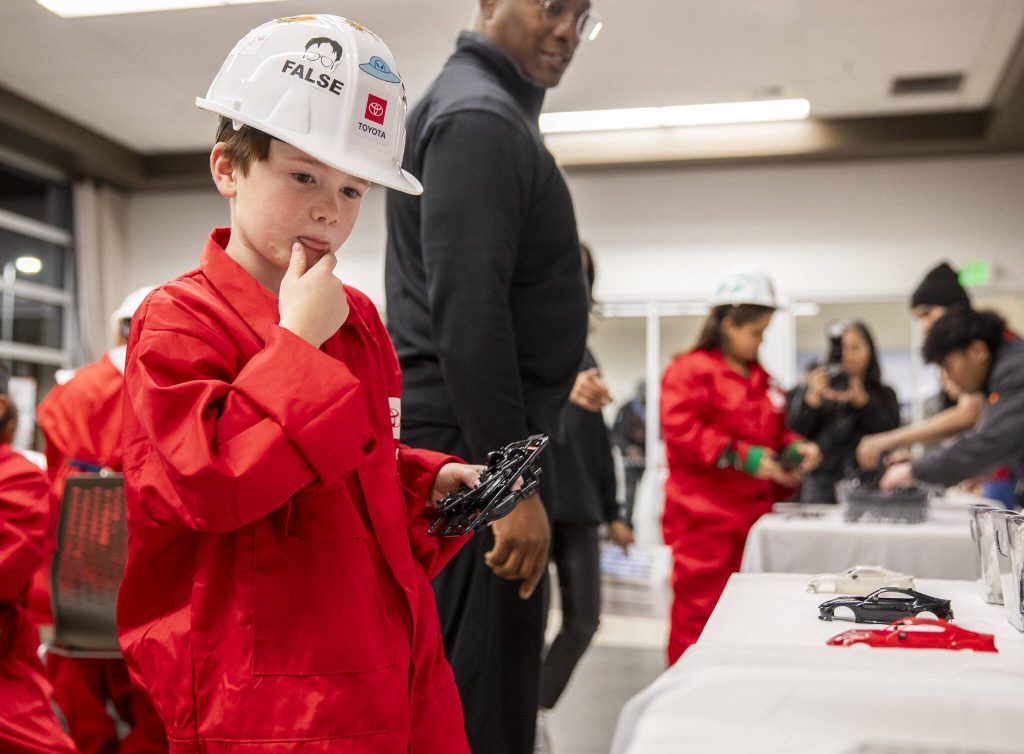 Charlie Bontempo, 9, thinks about what color car he wants while picking out his car body during Toyota Mini Makers Garage on Monday, Dec. 9, 2024 in Marysville, Washington. (Olivia Vanni / The Herald)