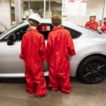 Local Boys & Girls Club children look at a life size model of the miniature car they built during Toyota Mini Makers Garage on Monday, Dec. 9, 2024 in Marysville, Washington. (Olivia Vanni / The Herald)