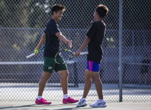 Jacksons Ben Lee, left, high-fives teammate Samuel Song, right, during a match against Kamiak on Monday, Sept. 30, 2024 in Mill Creek, Washington. (Olivia Vanni / The Herald)