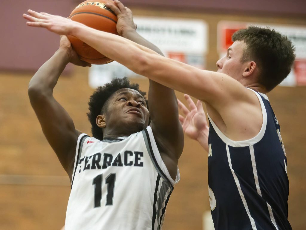 Mountlake Terraces Rayshaun Connor tries to take jump shot while being guarded during the game against Arlington on Tuesday, Dec. 10, 2024 in Mountlake Terrace, Washington. (Olivia Vanni / The Herald)