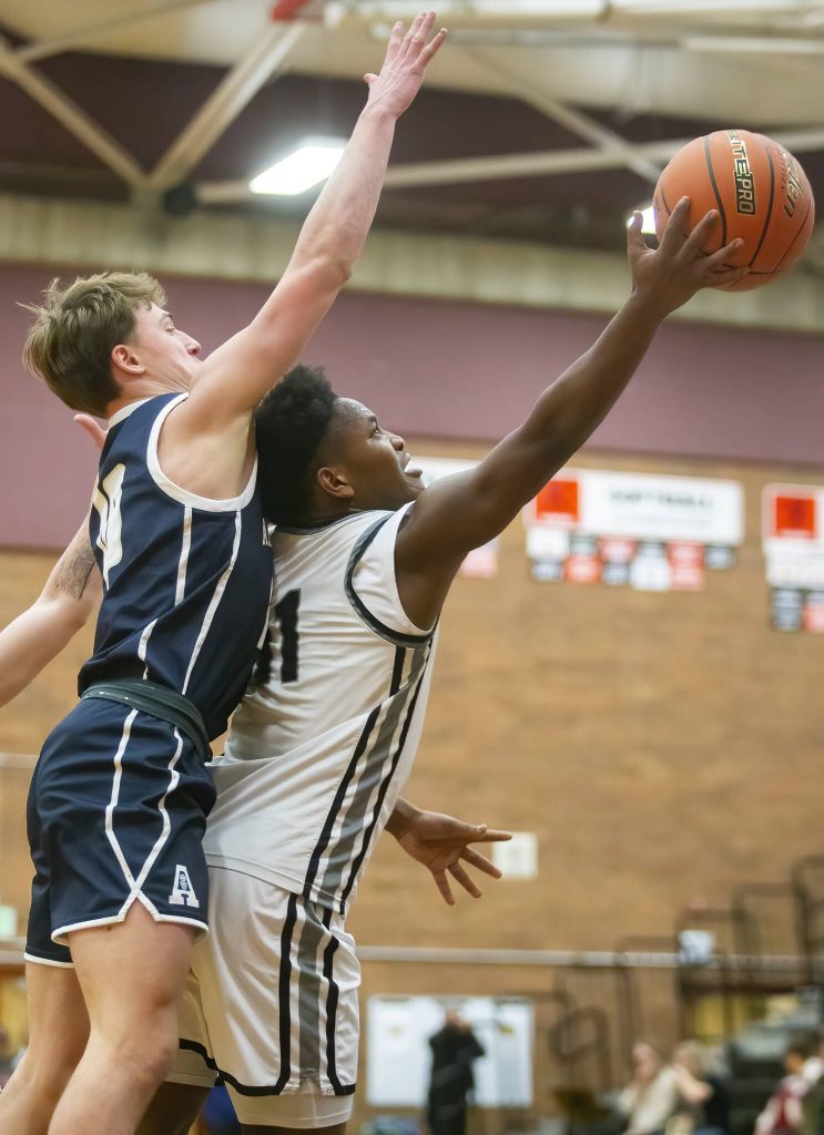 Mountlake Terraces Rayshaun Connor is fouled while making a layup during the game against Arlington on Tuesday, Dec. 10, 2024 in Mountlake Terrace, Washington. (Olivia Vanni / The Herald)