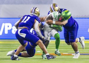 L.E. Baskow / Las Vegas Review-Journal / Tribune News Services
Oregon Ducks wide receiver Kris Hutson (1), who played for Washinginton State in 2024, is taken down by Washington Huskies linebacker Edefuan Ulofoshio (56) and teammates during the second half of their Pac-12 Football Championship game at Allegiant Stadium on Dec. 1, 2023, in Las Vegas.
