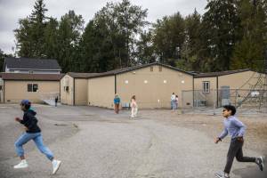 Students run past older portable classrooms at Glenwood Elementary on Monday, Sept. 9, 2024 in Lake Stevens, Washington. (Olivia Vanni / The Herald)