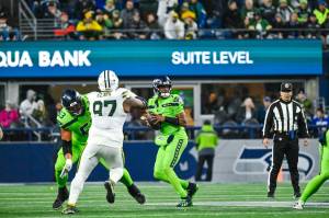 Seahawks quarterback Geno Smith looks for a receiver against the Green Bay Packers at Lumen Field on Sunday, Dec. 15, 2024. (Photo courtesy of Edwin Hooper / Seattle Seahawks)