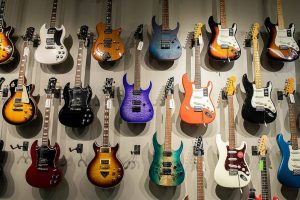 Colorful guitars for sale cover the wall inside Kennelly Keys on Thursday, Oct. 17, 2024 in Everett, Washington. (Olivia Vanni / The Herald)