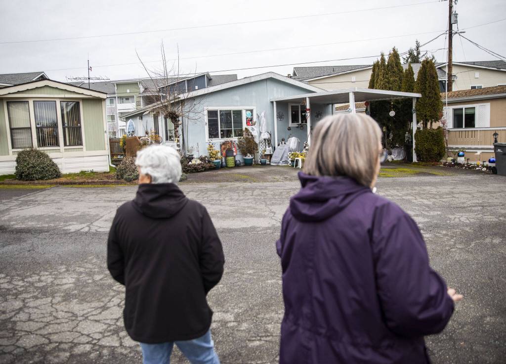 Royalwood Estates Mobile Home Park residents Patsy Gilbert, left, and Elna Olson, right, give a brief tour of the mobile home park on March 11, 2024 in Lynnwood, Washington. (Olivia Vanni / The Herald)