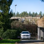 A cement block wall holds back refuse at United Recycling and Containers behind a home on March 5 in Snohomish, Washington. Years ago, the homes on 109th Ave SE overlooked a 150-foot drop into an old gravel pit. (Ryan Berry / Herald file)