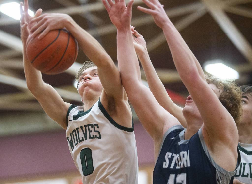 Jacksons Jackson Rabe leaps up for a rebound during the game against Squalicum on Friday, Dec. 27, 2024 in Mountlake Terrace, Washington. (Olivia Vanni / The Herald)