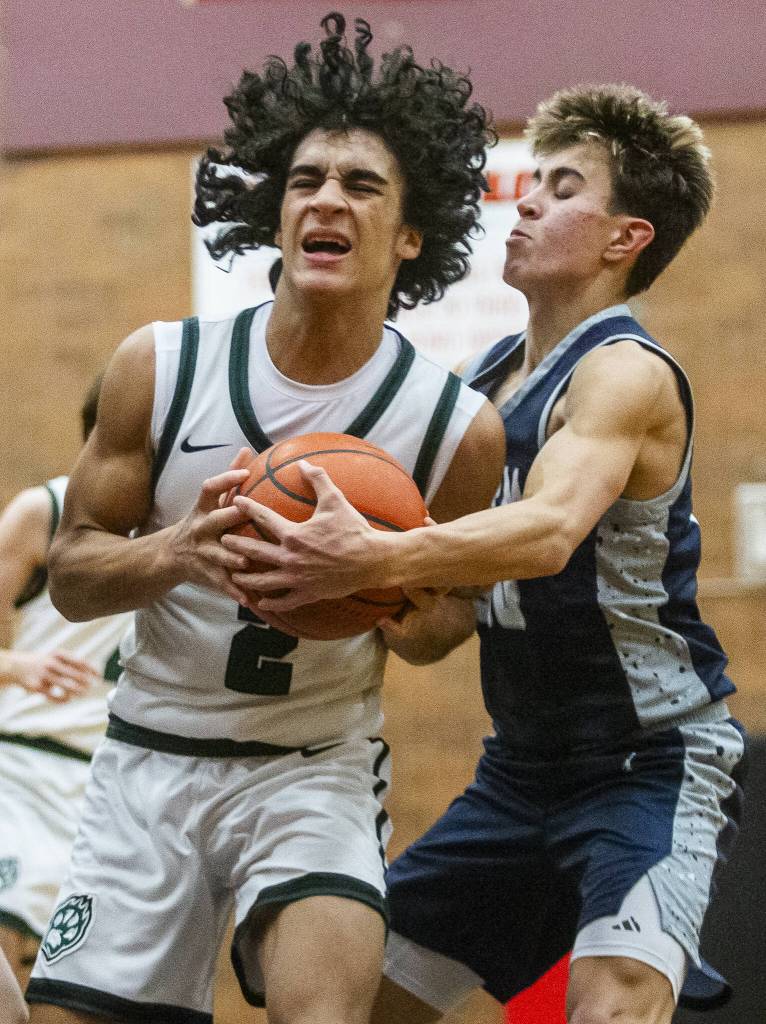 Jacksons Seamus Williams tries to keep possession of the ball during the game against Squalicum on Friday, Dec. 27, 2024 in Mountlake Terrace, Washington. (Olivia Vanni / The Herald)