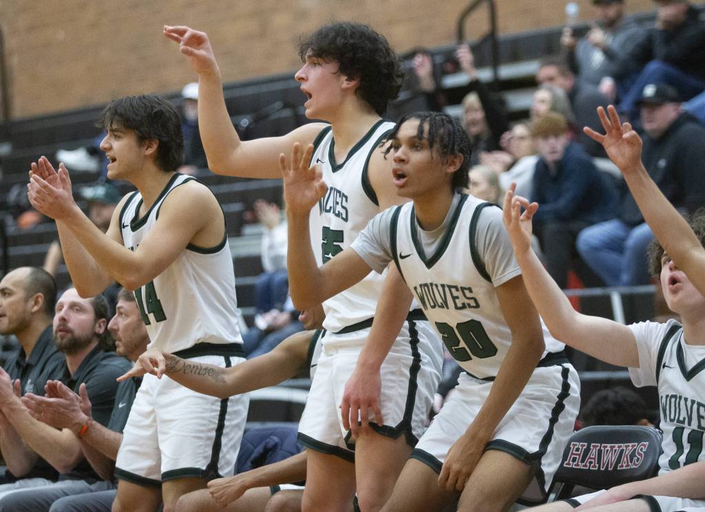 The Jackson bench reacts to a teammate making a three point shot during the game against Squalicum on Friday, Dec. 27, 2024 in Mountlake Terrace, Washington. (Olivia Vanni / The Herald)
