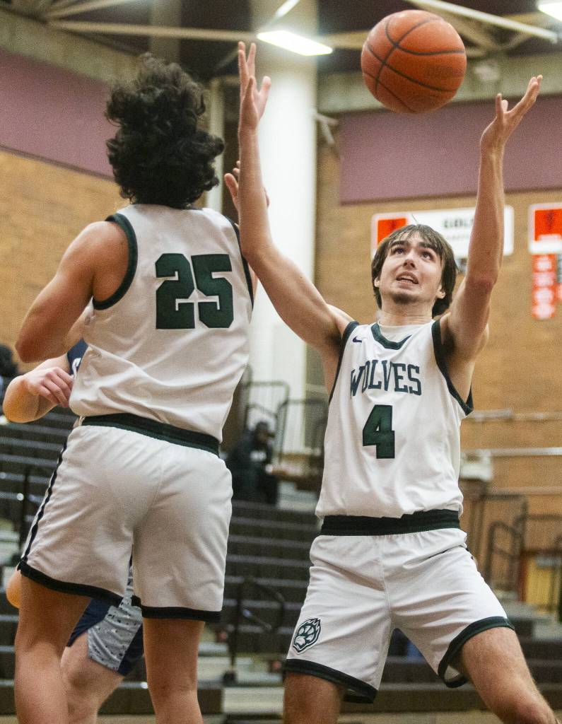 Jacksons Drew Pepin reaches up for a rebound during the game against Squalicum on Friday, Dec. 27, 2024 in Mountlake Terrace, Washington. (Olivia Vanni / The Herald)