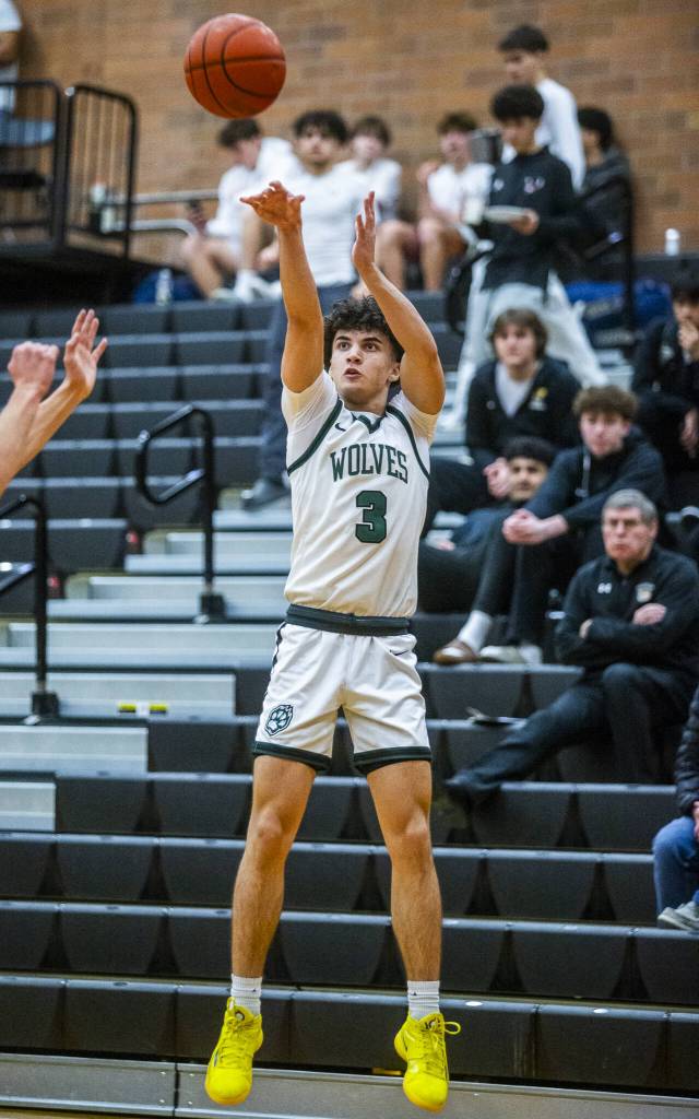 Jacksons Mason Engen takes a shot from the three-point line during the game against Squalicum on Friday, Dec. 27, 2024 in Mountlake Terrace, Washington. (Olivia Vanni / The Herald)
