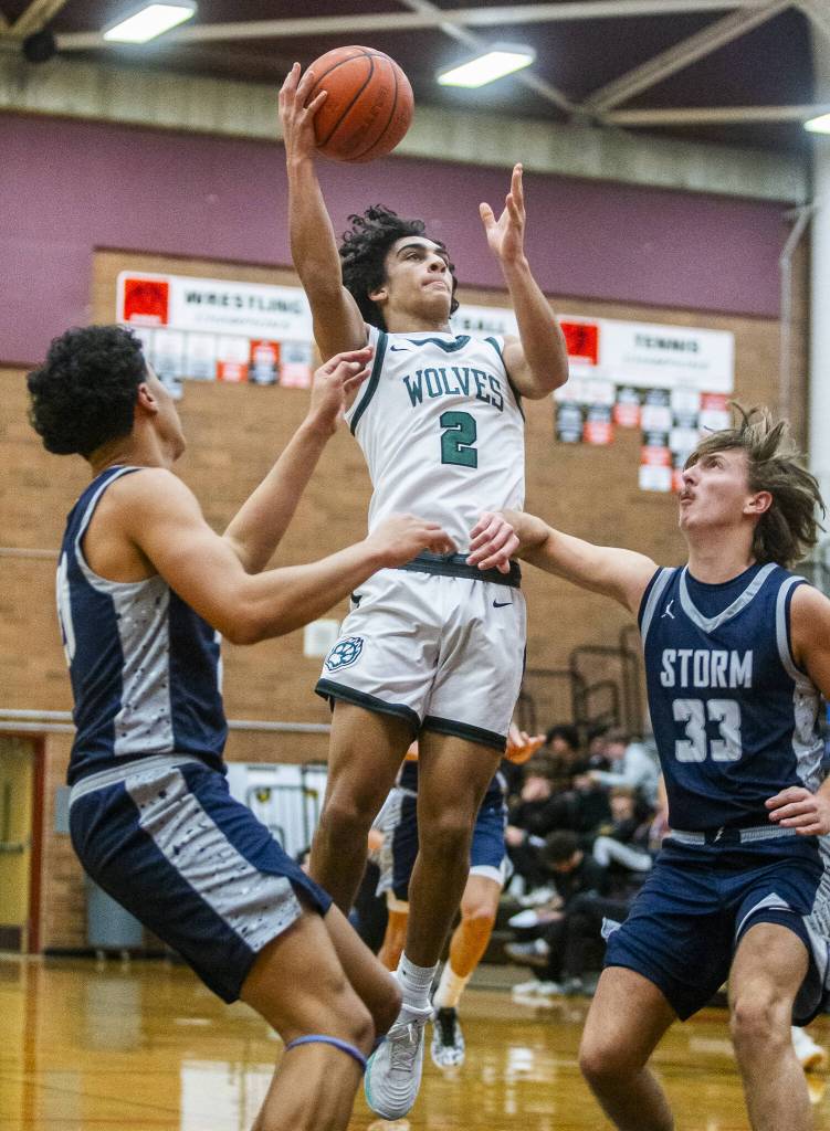 Jacksons Seamus Williams leaps in the air to make a jump shot during the game against Squalicum on Friday, Dec. 27, 2024 in Mountlake Terrace, Washington. (Olivia Vanni / The Herald)