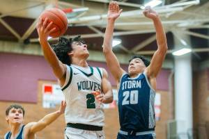 Jackson’s Seamus Williams reaches around for a layup during the game against Squalicum on Friday, Dec. 27, 2024 in Mountlake Terrace, Washington. (Olivia Vanni / The Herald)