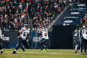 Seahawks quarterback Geno Smith (7) looks for a receiver against the Chicago Bears at Soldier Field on Thursday, Dec. 26, 2024. (Photo courtesy of Edwin Hooper / Seattle Seahawks)