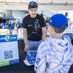 Sound Transit employee Alex Ko hands out maps during the Lynnwood 1 Line extension opening celebrations on Friday, Aug. 30, 2024 in Lynnwood, Washington. (Olivia Vanni / The Herald)
