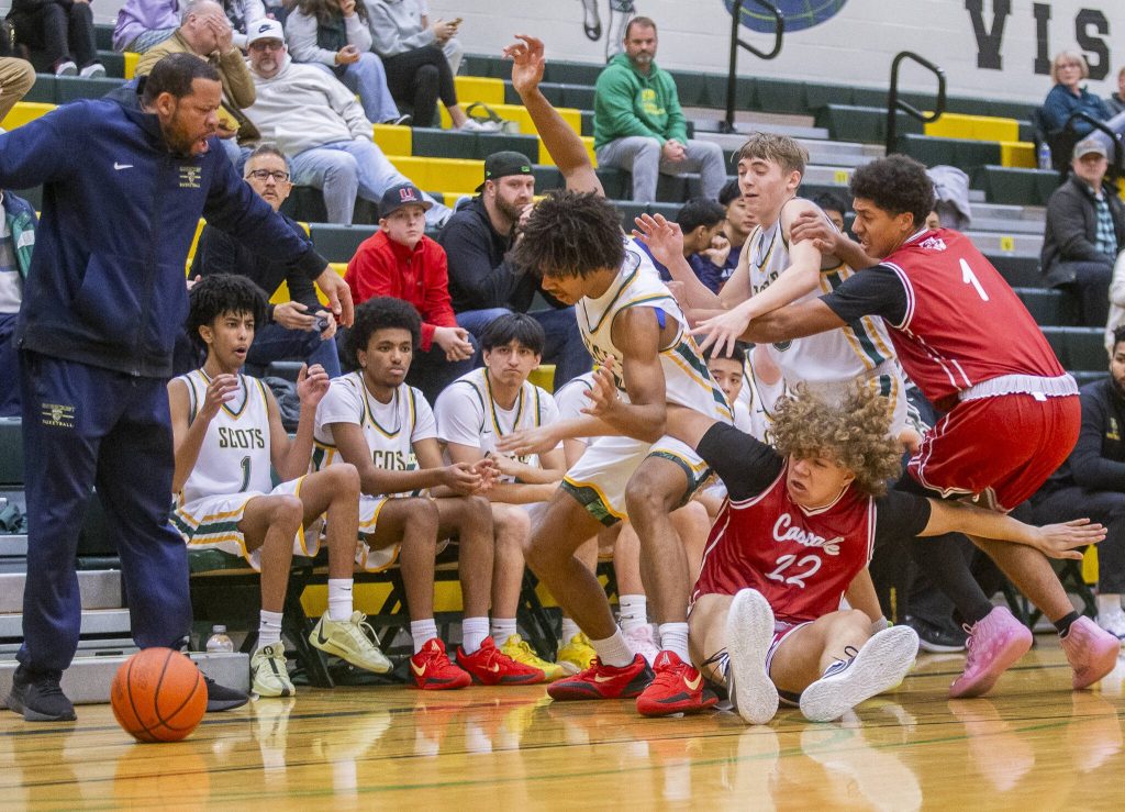 Cascades Gavin Wright falls to the ground during a scramble for a loose ball during the game against Shorecrest on Monday, Dec. 30, 2024 in Shoreline, Washington. (Olivia Vanni / The Herald)