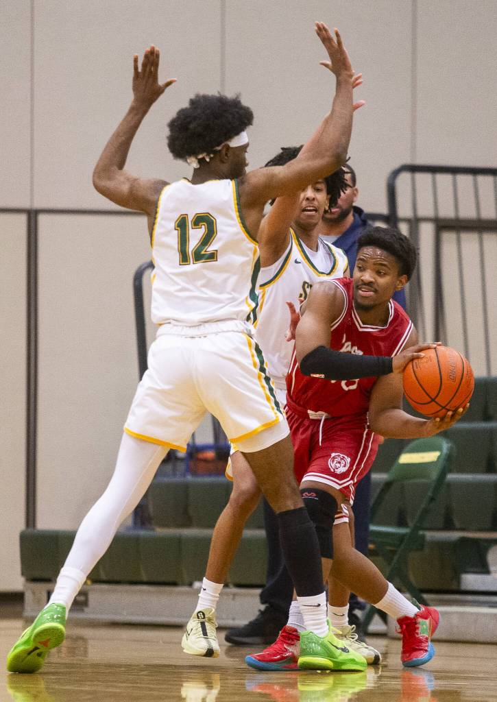 Cascades Noel Kisanga tries to pass the ball around Shorecrests Junior Kagarabi during the game on Monday, Dec. 30, 2024 in Shoreline, Washington. (Olivia Vanni / The Herald)