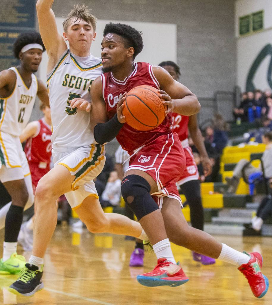 Cascades Noel Kisanga tries to get around Shorecrests Brayden Fischer to make a layup during the game on Monday, Dec. 30, 2024 in Shoreline, Washington. (Olivia Vanni / The Herald)